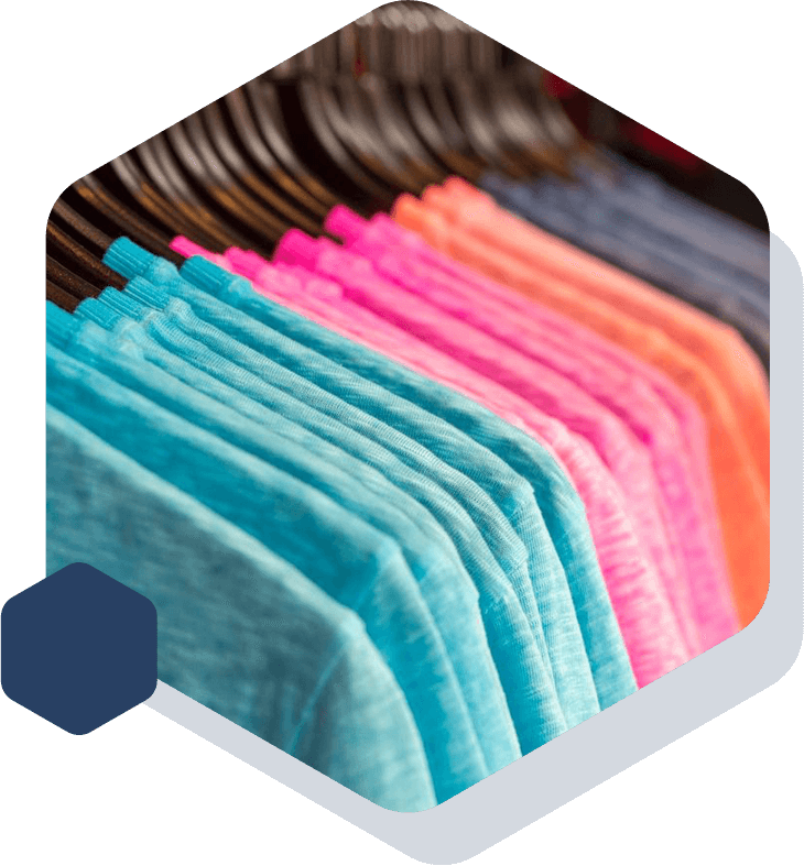 A close-up of a row of hanging multicoloured T-shirts.